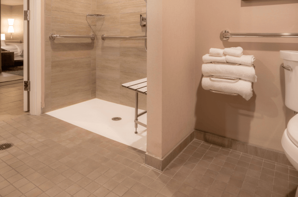 Bathroom with accessible, roll-in shower and grab bars everywhere. Nice.